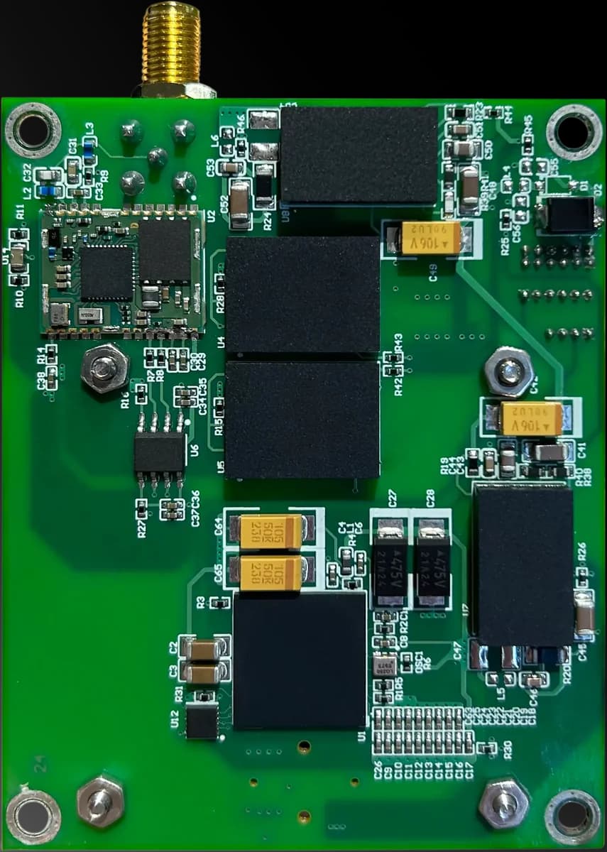 A green IMU board with an antenna connector on top and mounting holes in each corner