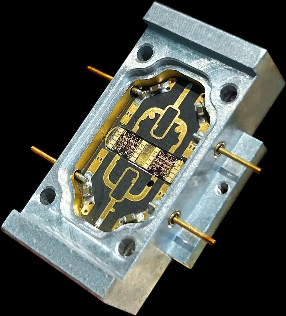 An RF module in a machined aluminium housing, with the gold circuit visible inside
