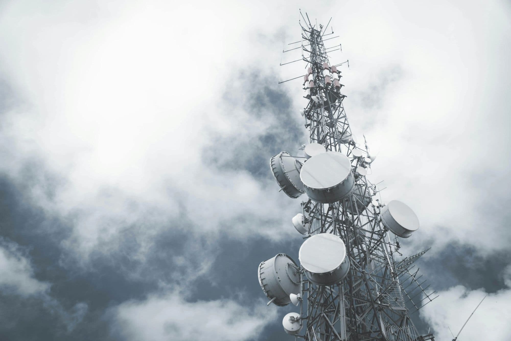 A communications mast in low cloud